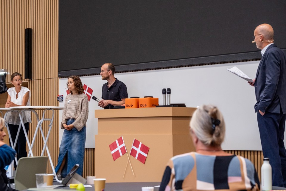 A panel of people on stage