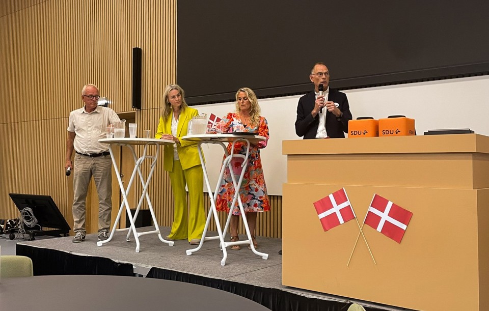 A panel of people on stage