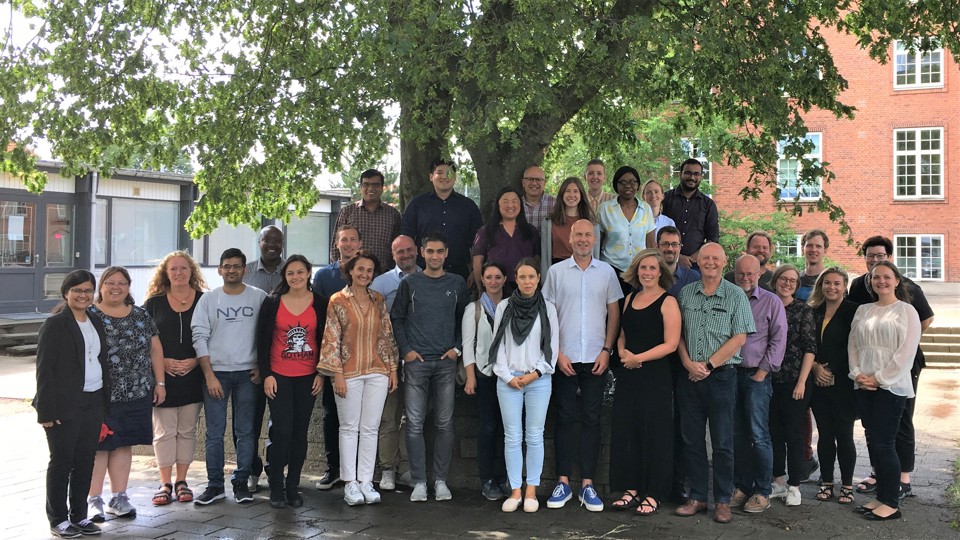 Group of people standing together and smiling at the camera